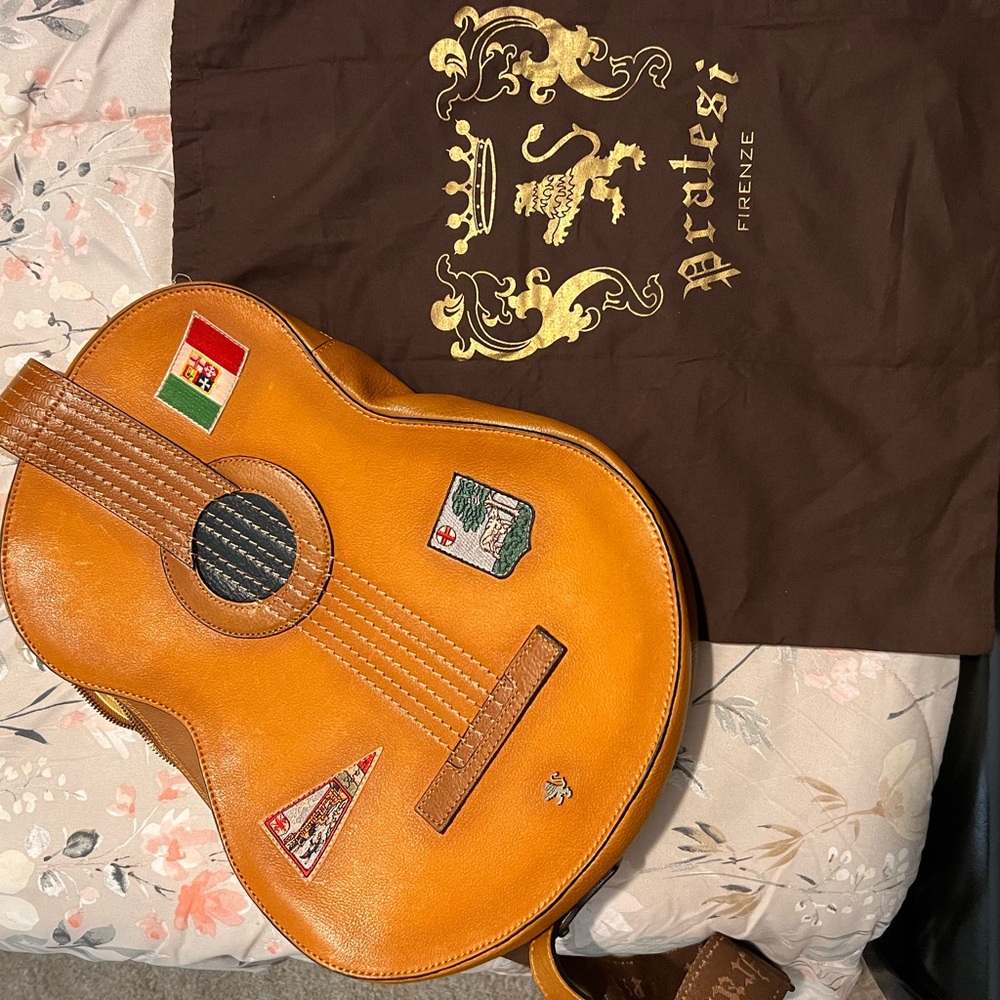 A vintage genuine Italian leather Pratesi Firenze crossbody guitar handbag.
